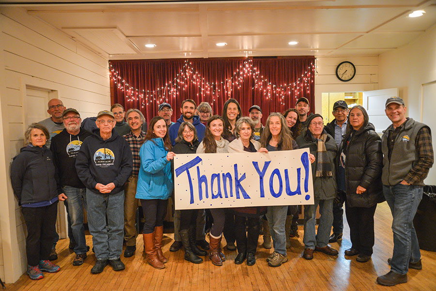 Group of GTMA volunteers holding "thank you" sign after stopping oil and gas drilling