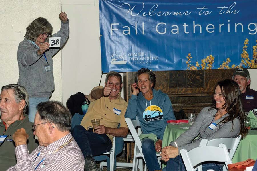 Ed and Laurie Stalling were having a great time while Gina Rink bids enthusiastically.